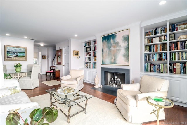 17 Harbour Vlg Unit F, Branford, CT 06405 - living area featuring built in features, wood finished floors, ornamental molding, a fireplace with flush hearth, and recessed lighting