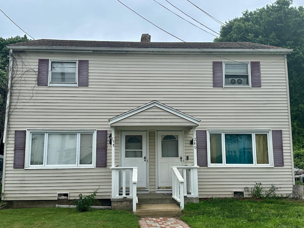 238 Larkin Ct, Stratford, CT 06615 - view of front of home with a front lawn and a chimney