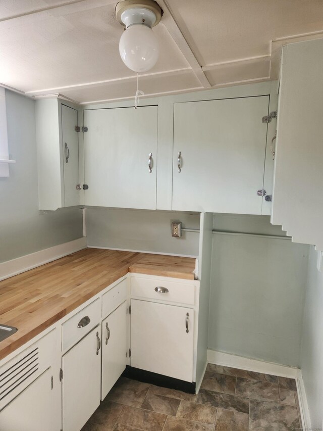 293 Central Ave, Norwich, CT 06360 - kitchen with white cabinetry, stone finish floors, and butcher block counters