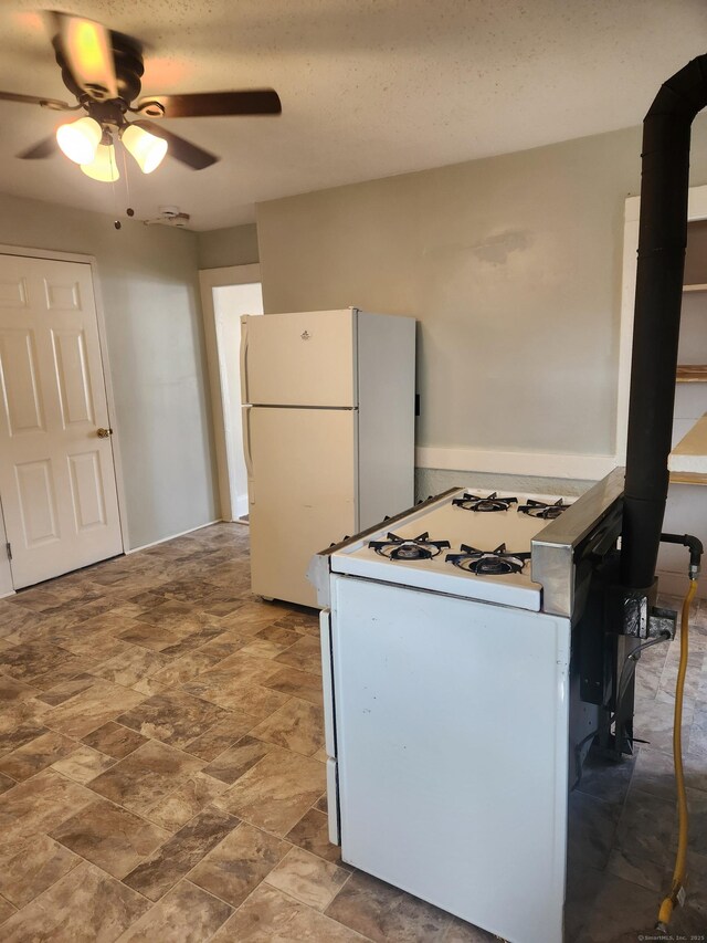 293 Central Ave, Norwich, CT 06360 - kitchen with white appliances, ceiling fan, and stone finish flooring