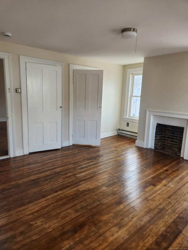 293 Central Ave, Norwich, CT 06360 - unfurnished living room with a baseboard heating unit, dark wood finished floors, and a fireplace