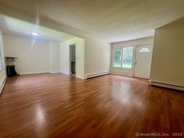 70 Watermelon Hill Rd, Carmel, NY 10541 - unfurnished living room featuring a baseboard radiator, wood finished floors, and baseboard heating