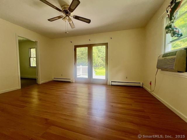 70 Watermelon Hill Rd, Carmel, NY 10541 - unfurnished room with a baseboard radiator, baseboard heating, wood finished floors, a ceiling fan, and a wall unit AC