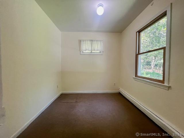 70 Watermelon Hill Rd, Carmel, NY 10541 - empty room with a baseboard radiator and dark colored carpet