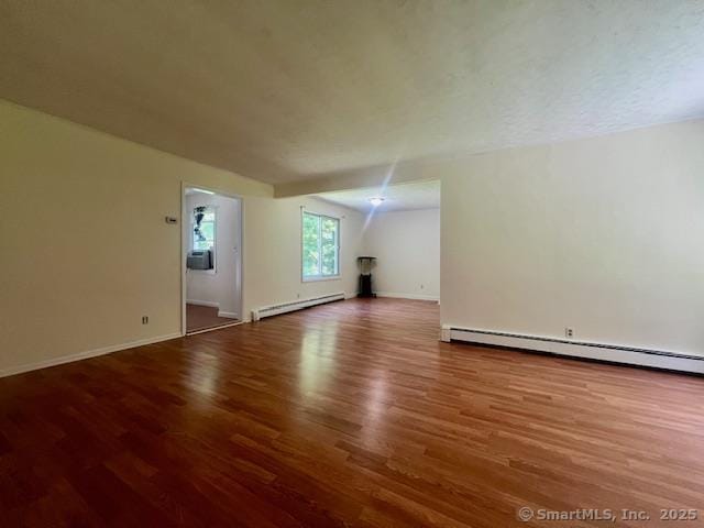 70 Watermelon Hill Rd, Carmel, NY 10541 - unfurnished living room featuring a baseboard heating unit, wood finished floors, and baseboard heating
