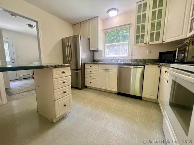 70 Watermelon Hill Rd, Carmel, NY 10541 - kitchen featuring stainless steel appliances, light flooring, glass insert cabinets, and dark stone counters