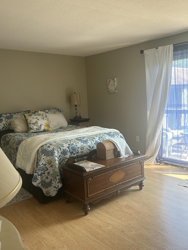 7 Harbour Vlg Unit A, Branford, CT 06405 - bedroom featuring wood finished floors and a textured ceiling