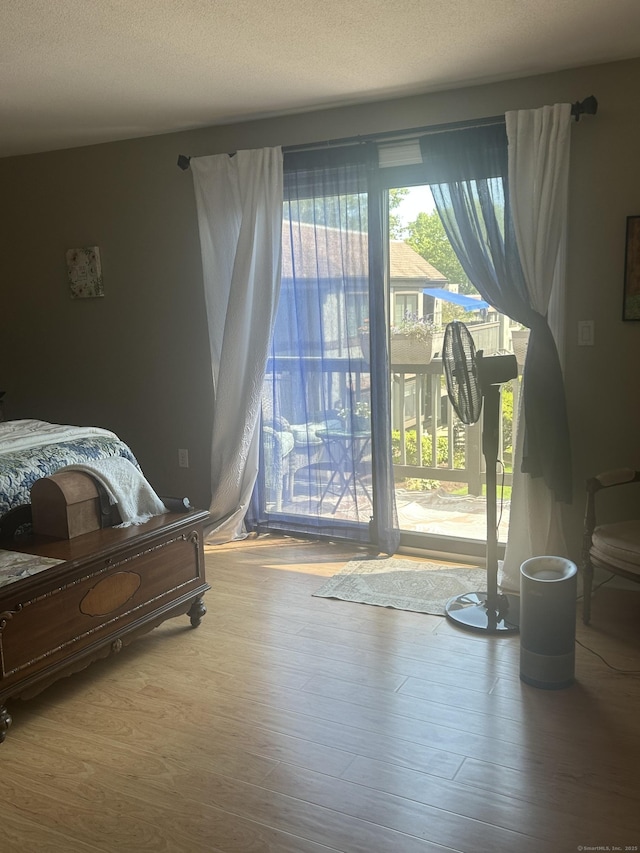 7 Harbour Vlg Unit A, Branford, CT 06405 - bedroom with access to exterior and wood finished floors