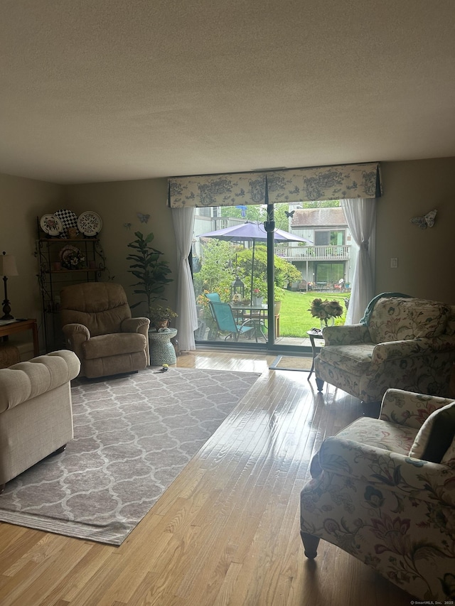 7 Harbour Vlg Unit A, Branford, CT 06405 - living area featuring wood finished floors and a textured ceiling