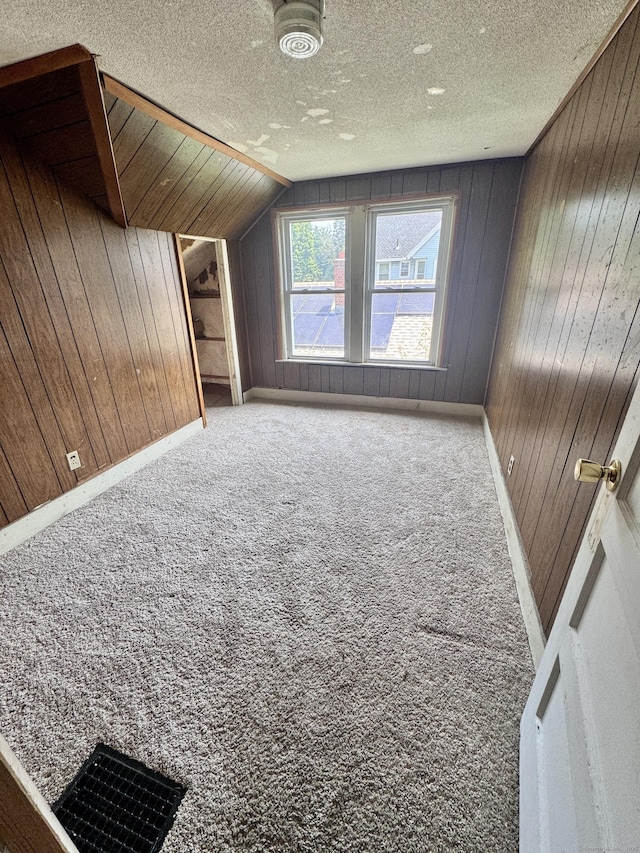 33 Wilson Ave, Windsor, CT 06095 - bonus room featuring wood walls, carpet flooring, vaulted ceiling, and a textured ceiling