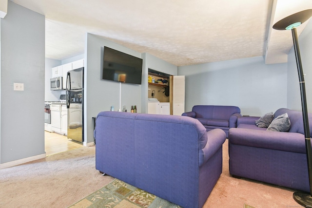 11 Cedar Ct Unit C, East Haven, CT 06513 - living area featuring light colored carpet and washing machine and clothes dryer
