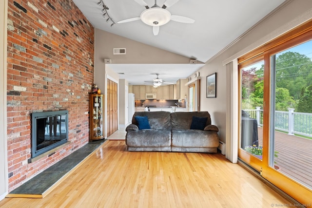 475 Pine Tree Dr, Orange, CT 06477 - living room with ceiling fan, light wood finished floors, a fireplace, and high vaulted ceiling