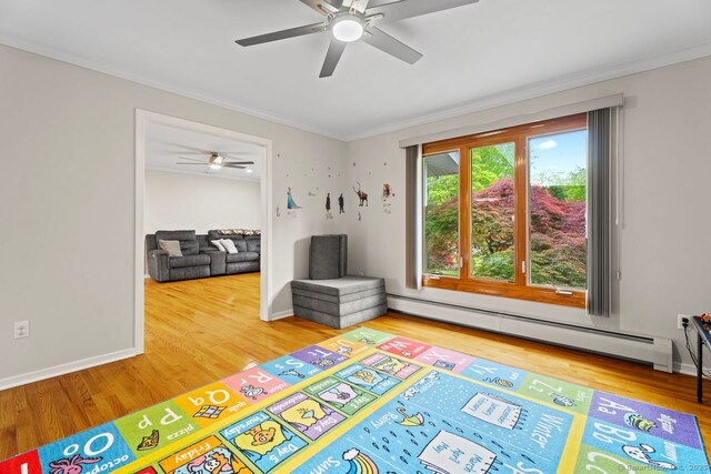 475 Pine Tree Dr, Orange, CT 06477 - game room with a baseboard radiator, ceiling fan, wood finished floors, and ornamental molding
