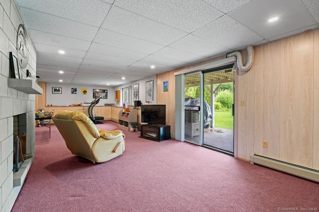 475 Pine Tree Dr, Orange, CT 06477 - carpeted living area featuring a fireplace, a baseboard radiator, a drop ceiling, recessed lighting, and wooden walls