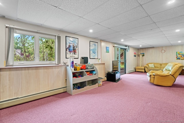 475 Pine Tree Dr, Orange, CT 06477 - carpeted living area with a baseboard heating unit, a paneled ceiling, recessed lighting, and wooden walls
