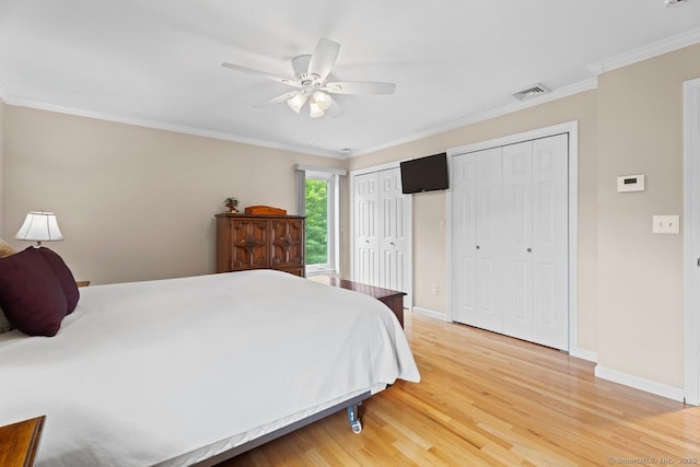 475 Pine Tree Dr, Orange, CT 06477 - bedroom featuring two closets, light wood-style flooring, ornamental molding, and ceiling fan