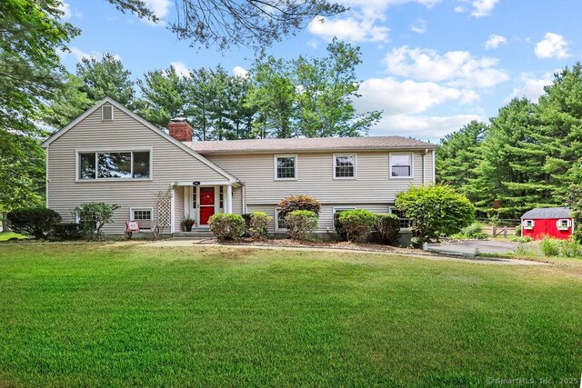 18 Chestnut Hill Rd, Simsbury, CT 06092 - bi-level home featuring a chimney, a front yard, and a storage unit