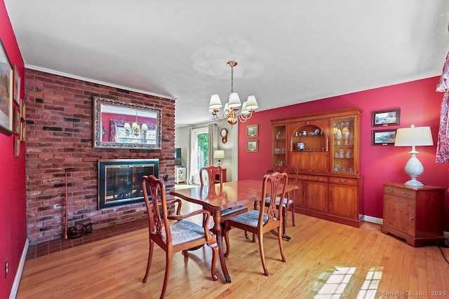 18 Chestnut Hill Rd, Simsbury, CT 06092 - dining space featuring light wood finished floors, a chandelier, and a fireplace