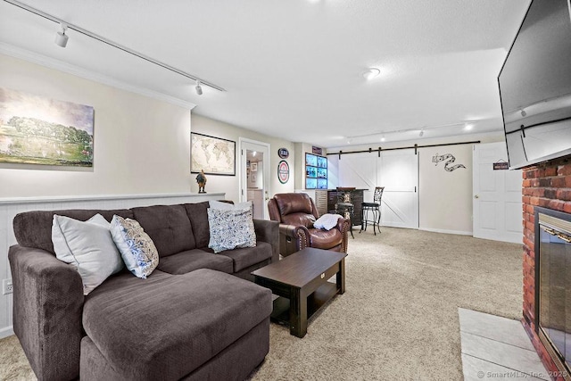 18 Chestnut Hill Rd, Simsbury, CT 06092 - living area featuring rail lighting, light colored carpet, a barn door, a brick fireplace, and ornamental molding