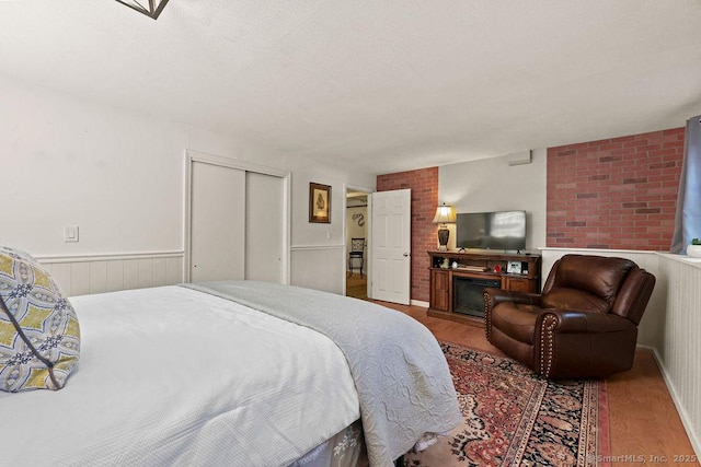 18 Chestnut Hill Rd, Simsbury, CT 06092 - bedroom featuring wood finished floors, a closet, and wainscoting