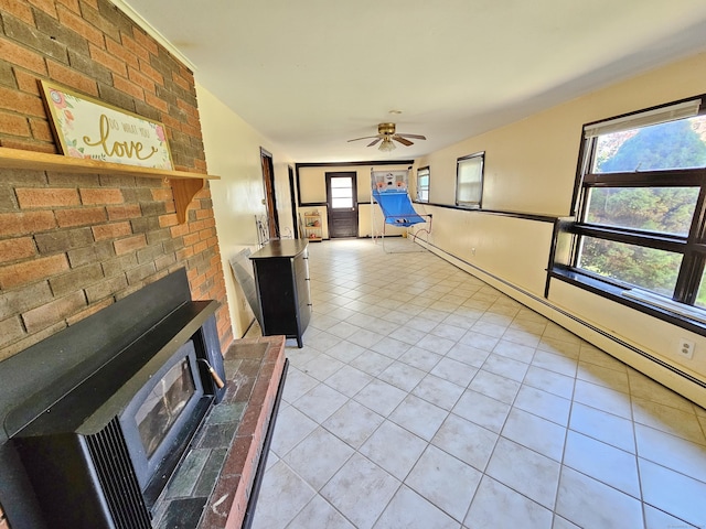 38 Sylvan Ave, Wallingford, CT 06492 - unfurnished living room featuring light tile patterned floors, plenty of natural light, a ceiling fan, and a wood stove