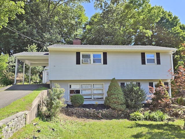 38 Sylvan Ave, Wallingford, CT 06492 - view of front of house with a chimney, asphalt driveway, and an attached carport
