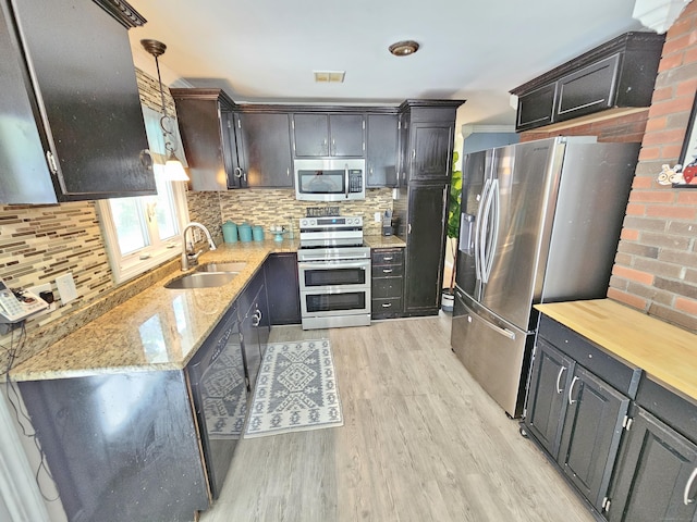 38 Sylvan Ave, Wallingford, CT 06492 - kitchen with stainless steel appliances, light wood finished floors, backsplash, and light stone counters