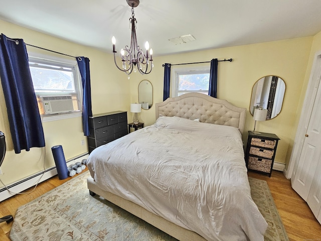 38 Sylvan Ave, Wallingford, CT 06492 - bedroom with a chandelier, cooling unit, and wood finished floors
