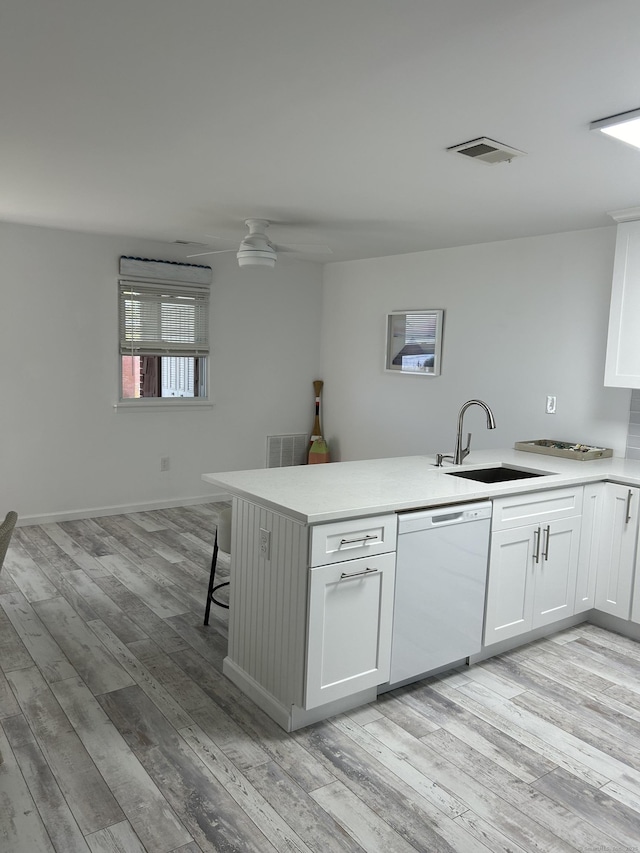 63 E Broadway Unit D, Milford, CT 06460 - kitchen featuring dishwasher, a peninsula, white cabinetry, and light wood-type flooring