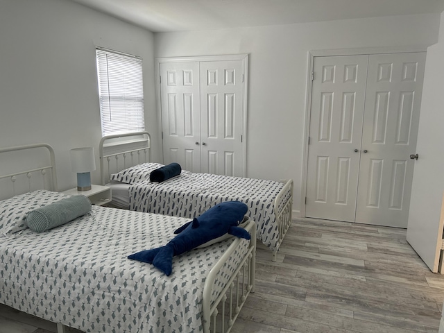 63 E Broadway Unit D, Milford, CT 06460 - bedroom featuring multiple closets and wood finished floors