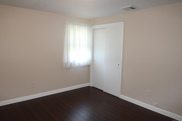 2337 Stanley St, New Britain, CT 06053 - empty room with dark wood finished floors and baseboards
