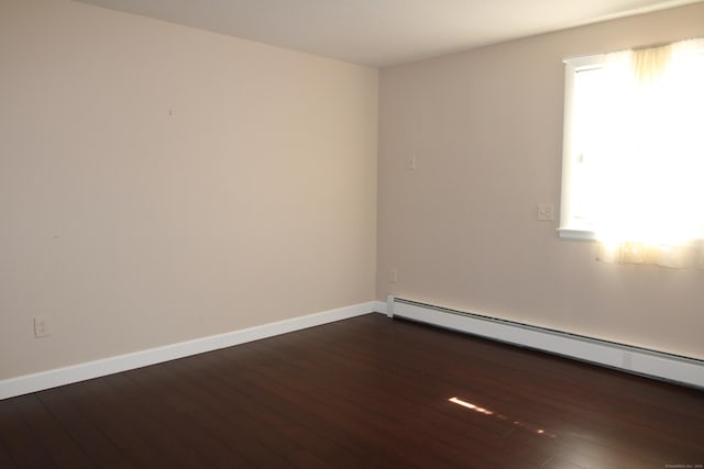 2337 Stanley St, New Britain, CT 06053 - spare room with a baseboard heating unit and wood-type flooring