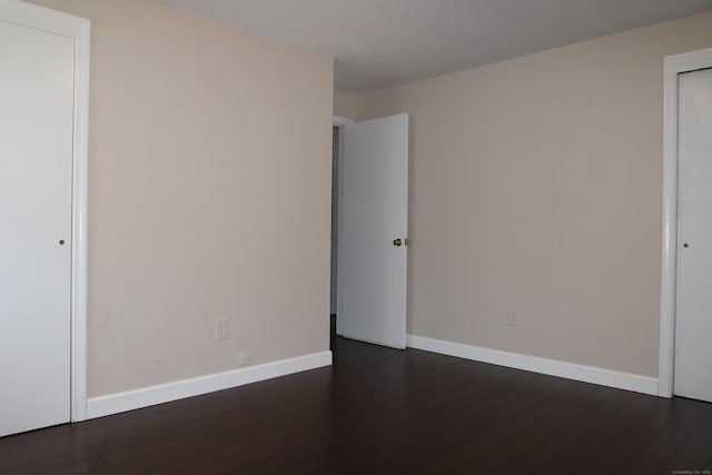2337 Stanley St, New Britain, CT 06053 - empty room with dark wood-style floors and a textured ceiling