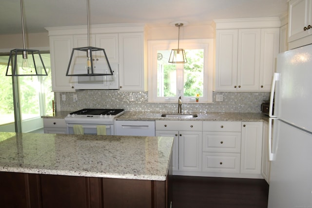 2337 Stanley St, New Britain, CT 06053 - kitchen with white appliances, backsplash, white cabinetry, and light stone counters