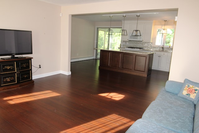 2337 Stanley St, New Britain, CT 06053 - living area with a baseboard radiator and dark wood-style flooring