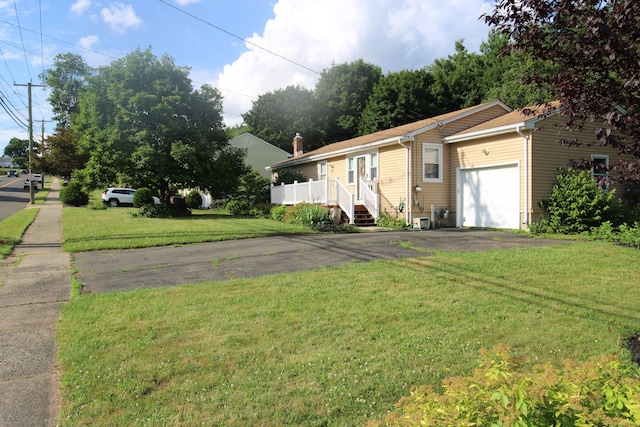 2337 Stanley St, New Britain, CT 06053 - view of front of house featuring a garage, driveway, and a front lawn