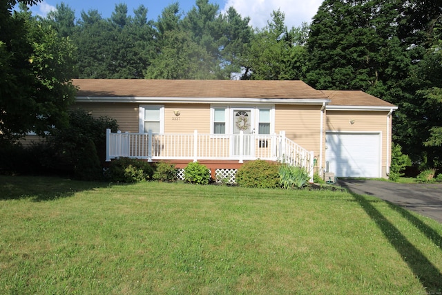 2337 Stanley St, New Britain, CT 06053 - single story home with a garage, a front yard, driveway, and a deck