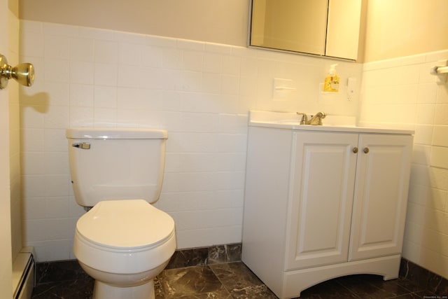 2337 Stanley St, New Britain, CT 06053 - bathroom with a baseboard heating unit, tile walls, vanity, marble finish flooring, and wainscoting