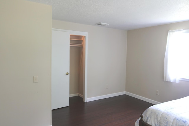 2337 Stanley St, New Britain, CT 06053 - bedroom with dark wood-style flooring and a textured ceiling