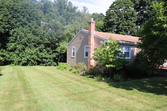 2337 Stanley St, New Britain, CT 06053 - view of side of home featuring a lawn and a chimney