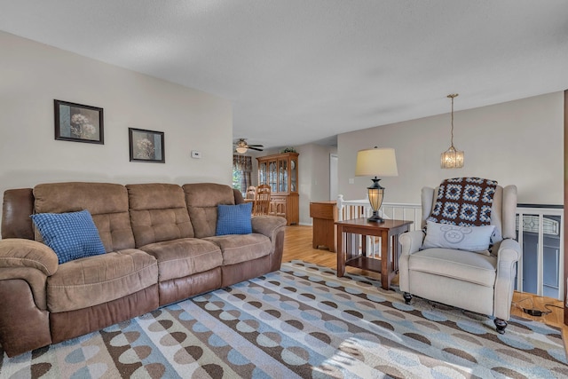 315 Judson Ave, Groton, CT 06355 - living room with a ceiling fan, a wainscoted wall, and a chandelier