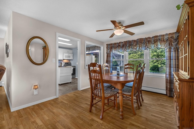 315 Judson Ave, Groton, CT 06355 - dining space with a baseboard heating unit, a ceiling fan, and light wood finished floors