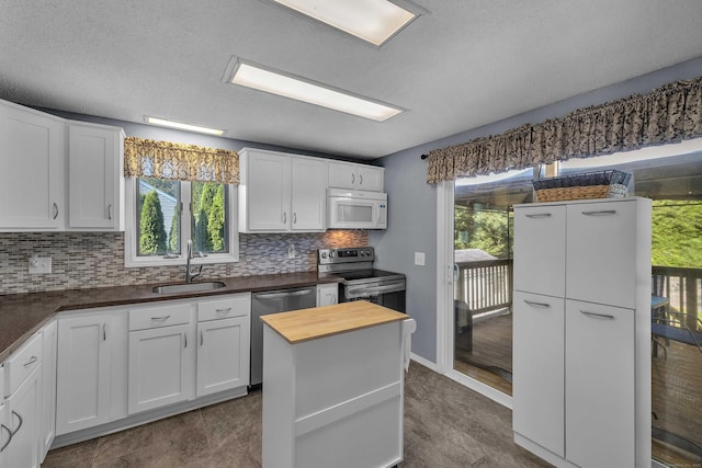 315 Judson Ave, Groton, CT 06355 - kitchen with stainless steel appliances, wooden counters, plenty of natural light, and decorative backsplash