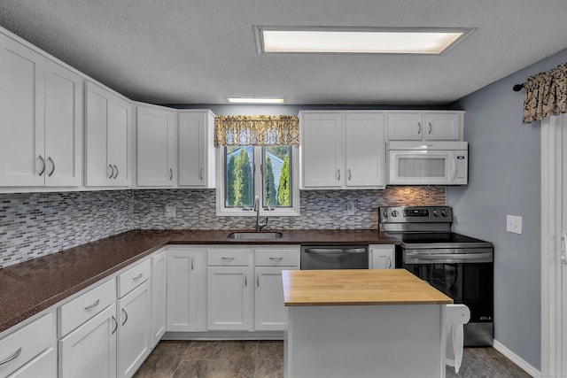 315 Judson Ave, Groton, CT 06355 - kitchen with appliances with stainless steel finishes, wood counters, white cabinets, and tasteful backsplash