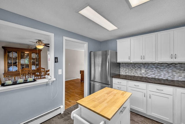 315 Judson Ave, Groton, CT 06355 - kitchen featuring a baseboard radiator, freestanding refrigerator, and white cabinets