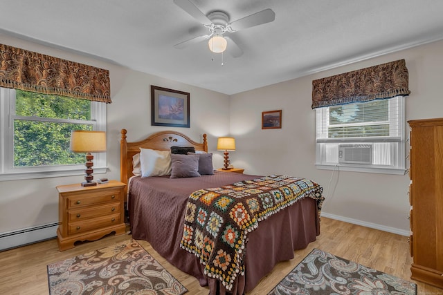315 Judson Ave, Groton, CT 06355 - bedroom featuring multiple windows, a baseboard radiator, cooling unit, and light wood finished floors