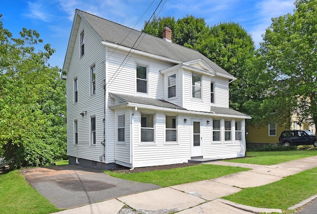 31 Chapman St, New Britain, CT 06051 - view of front facade featuring a chimney, a shingled roof, and a front lawn