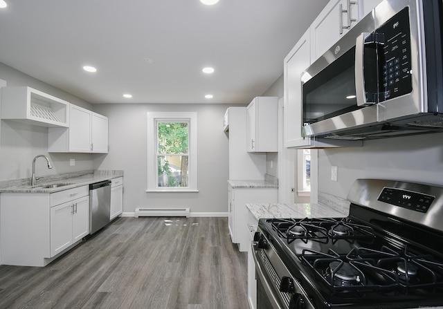 31 Chapman St, New Britain, CT 06051 - kitchen with stainless steel appliances, light stone countertops, wood finished floors, open shelves, and white cabinetry