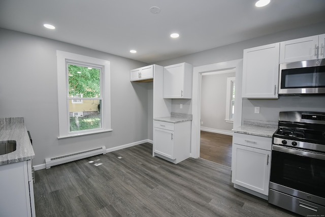 31 Chapman St, New Britain, CT 06051 - kitchen with stainless steel appliances, baseboard heating, white cabinets, dark wood-type flooring, and recessed lighting
