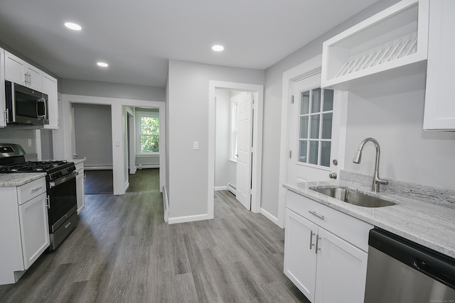 31 Chapman St, New Britain, CT 06051 - kitchen featuring appliances with stainless steel finishes, white cabinetry, wood finished floors, light stone counters, and recessed lighting